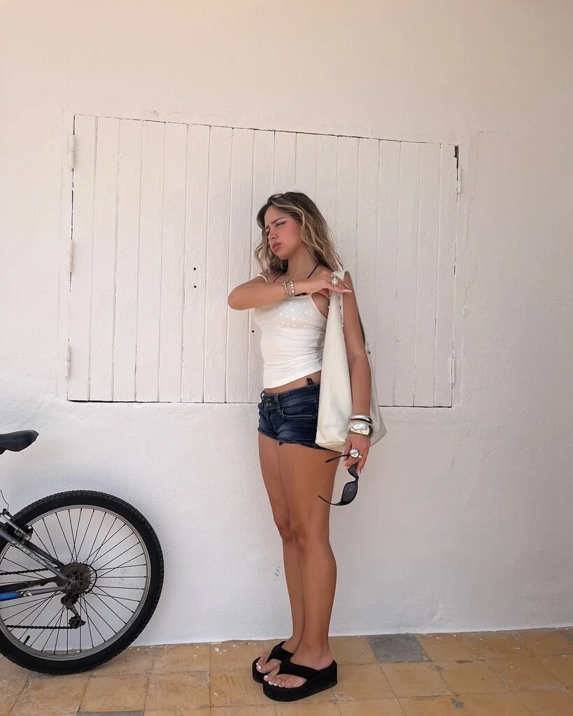 Edgy low-rise double-button denim shorts—hip-hugging hot pants.