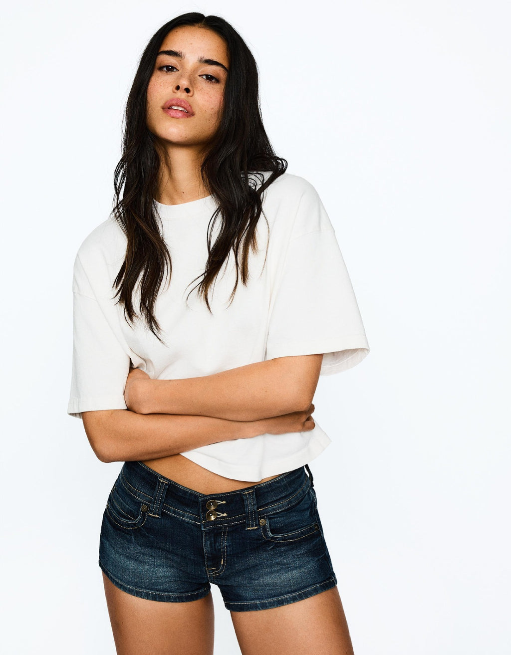 Edgy low-rise double-button denim shorts—hip-hugging hot pants.