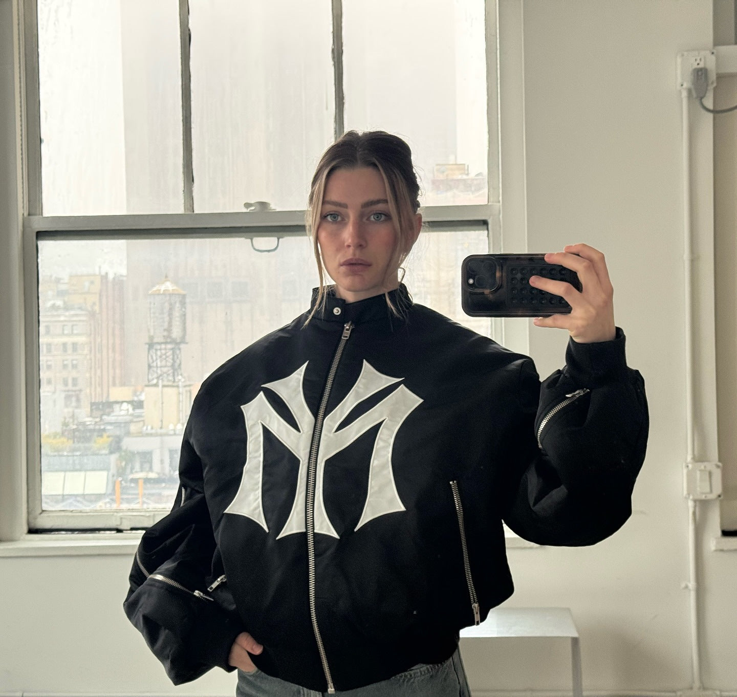 oose-fit sweatshirt with multi-zipper design and letter embroidery.