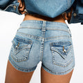 Edgy low-rise double-button denim shorts—hip-hugging hot pants.