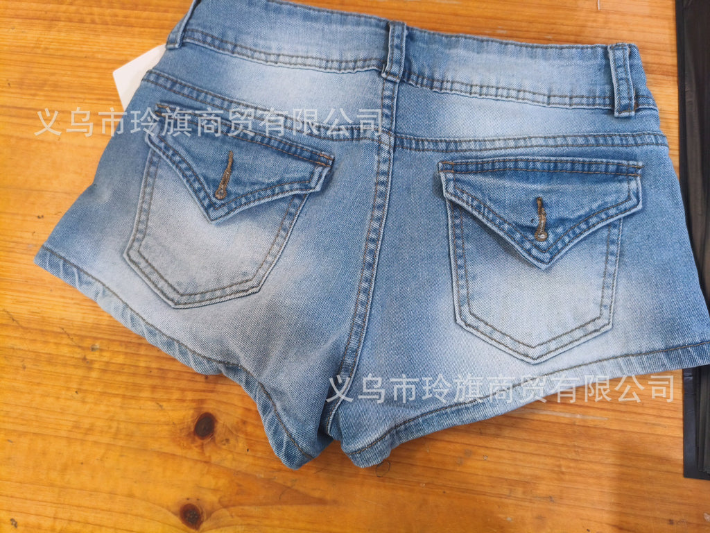 Edgy low-rise double-button denim shorts—hip-hugging hot pants.