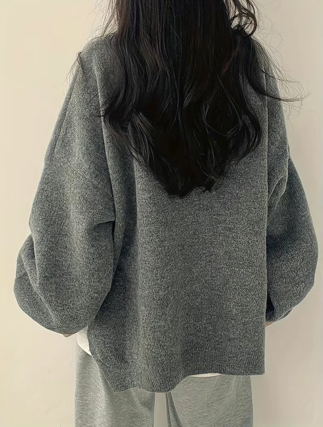 Solid-color, loose-fit, long-sleeve knit pullover with side slits