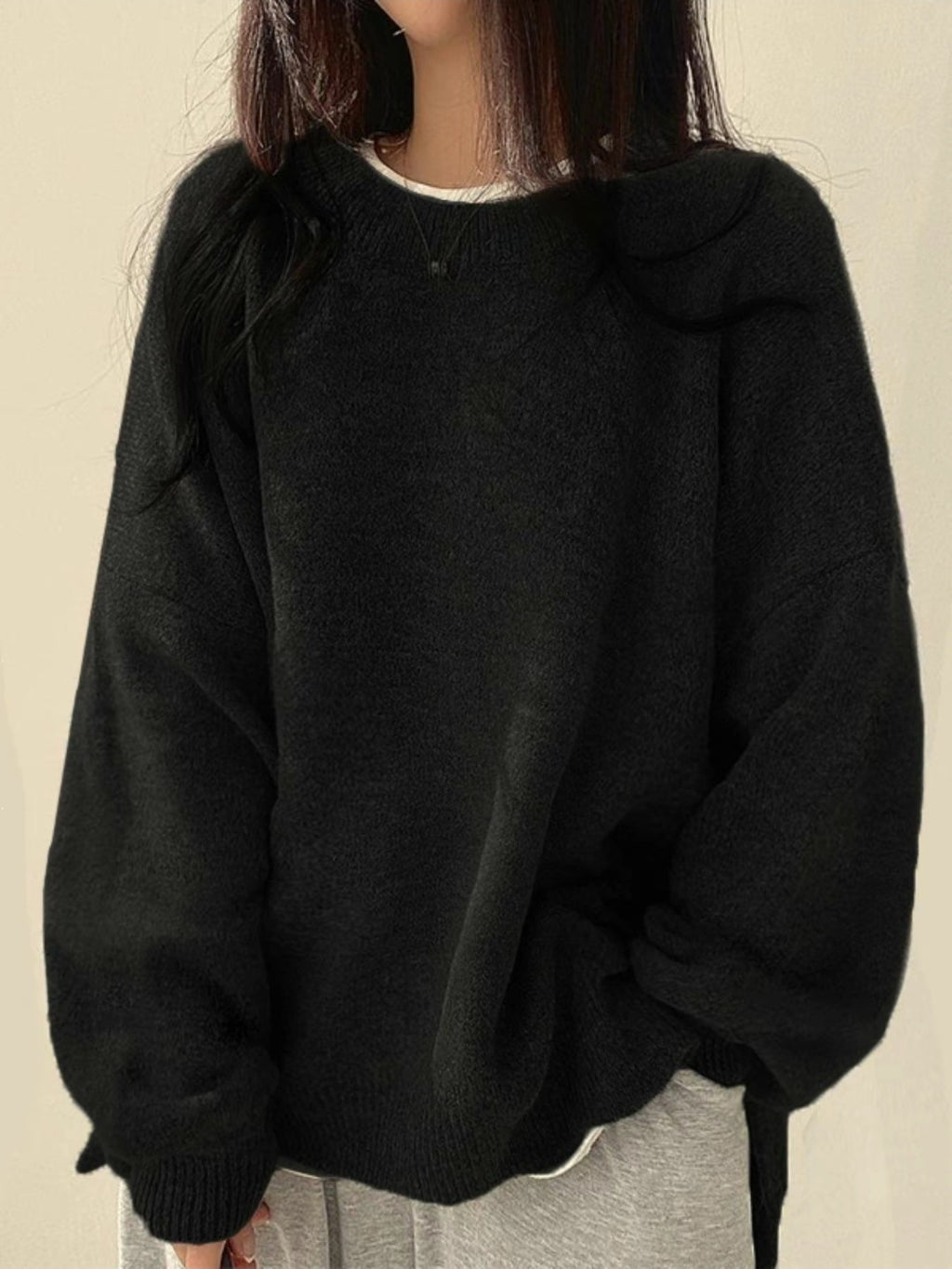 Solid-color, loose-fit, long-sleeve knit pullover with side slits