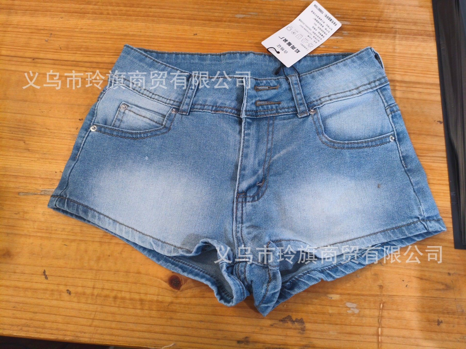 Edgy low-rise double-button denim shorts—hip-hugging hot pants.