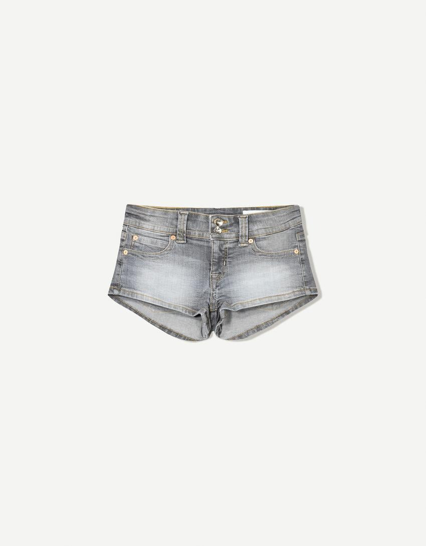 Edgy low-rise double-button denim shorts—hip-hugging hot pants.