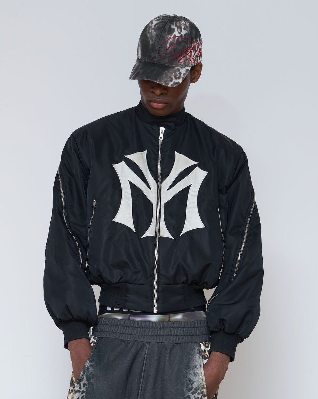 oose-fit sweatshirt with multi-zipper design and letter embroidery.
