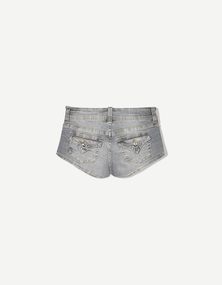 Edgy low-rise double-button denim shorts—hip-hugging hot pants.